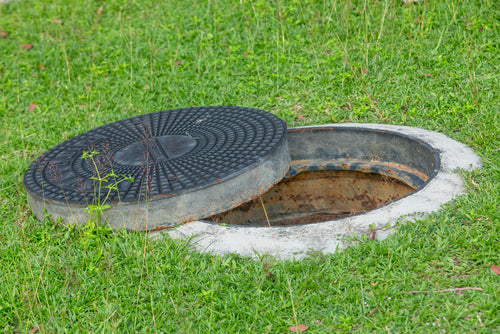 6 Ways to Disguise Drain Covers in a Garden